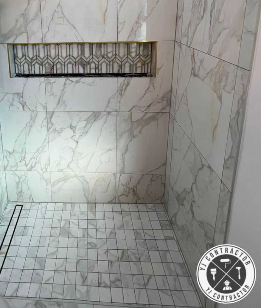 White marble-look shower tile with a decorative recessed niche