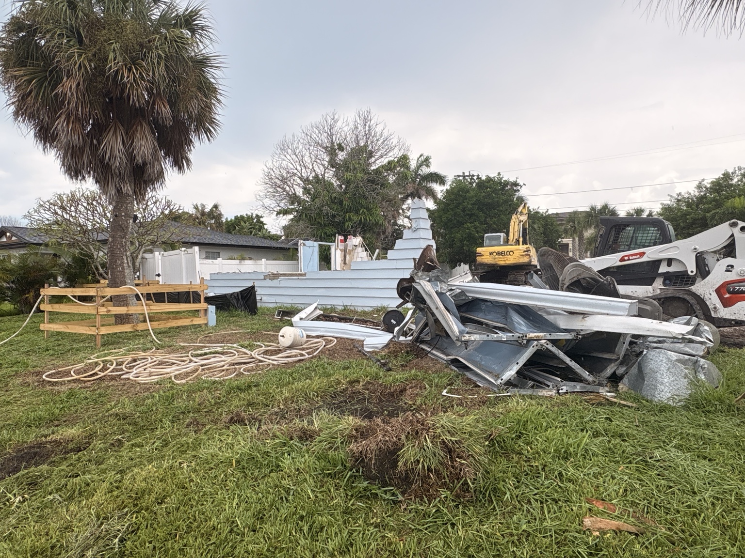 Demolition debris and excavation equipment on an active job site