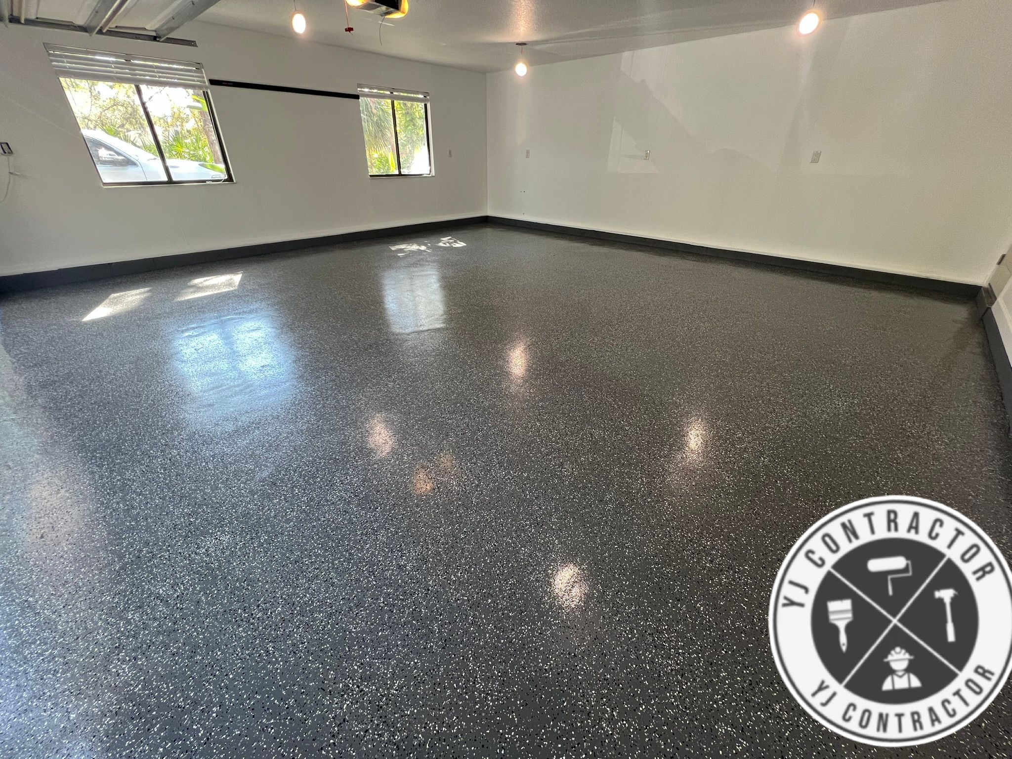 Glossy charcoal flake epoxy floor in a finished garage