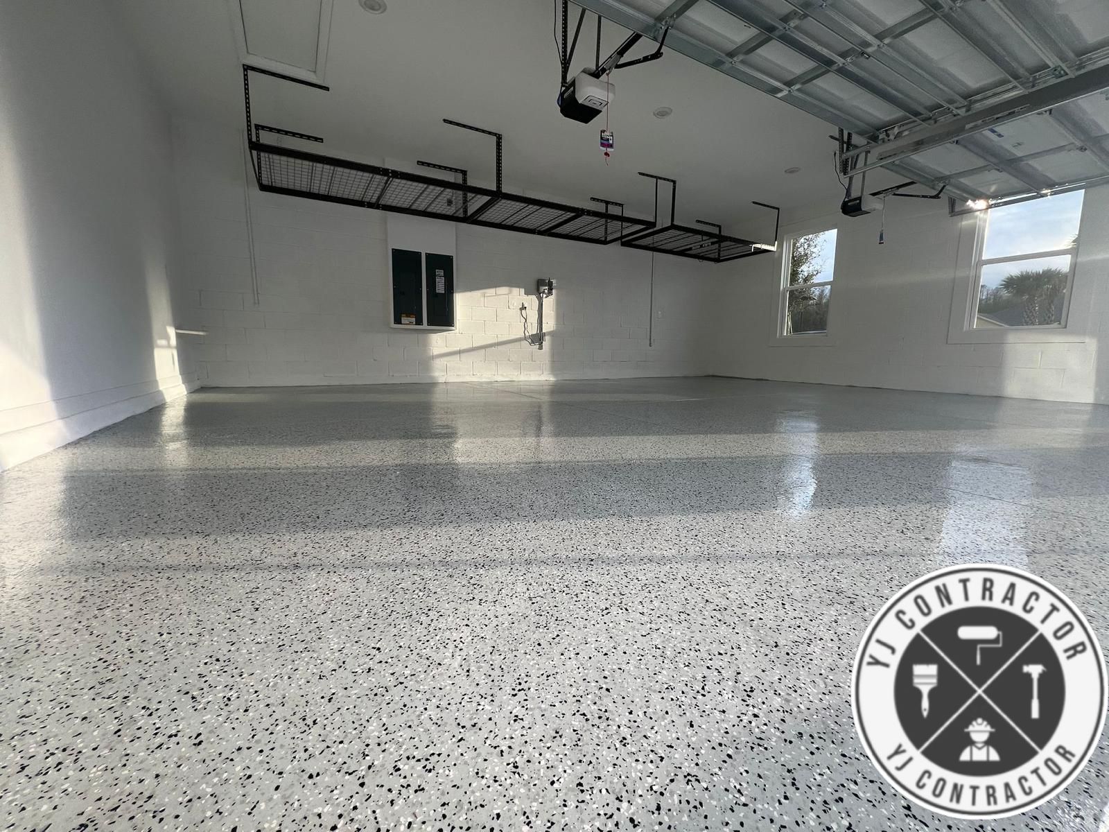 Finished light gray flake epoxy flooring across an open garage