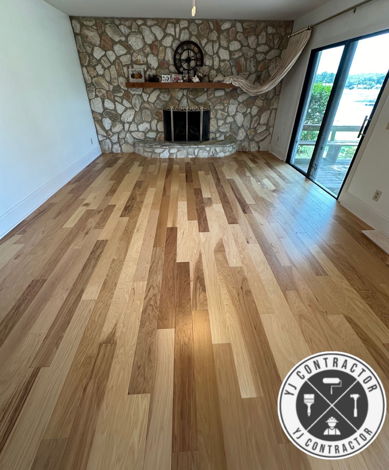 Wood-look floor in a living room with stone fireplace