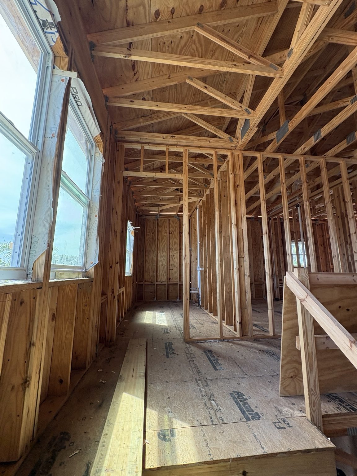 Interior framing along a windowed corridor