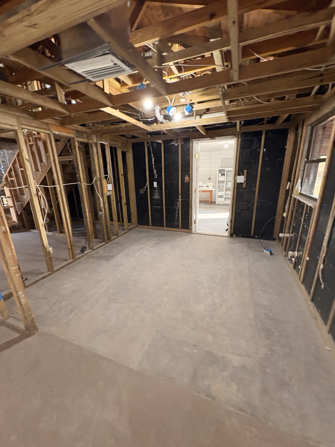Room stripped to wall studs during an interior demolition project
