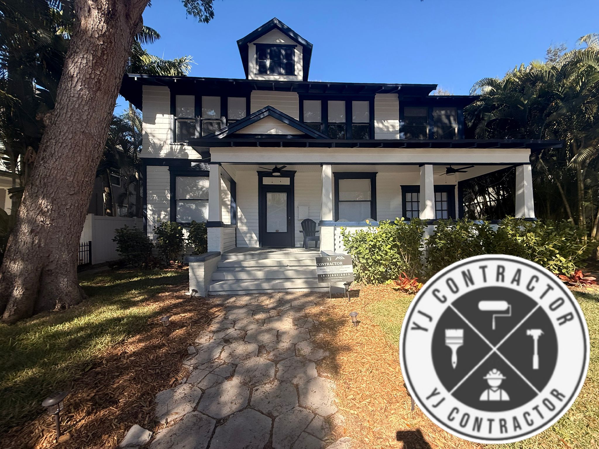 Completed white home exterior with dark painted trim