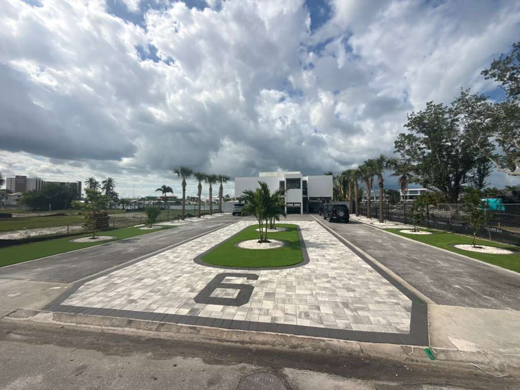 Wide paver driveway with geometric design and landscaped center islands