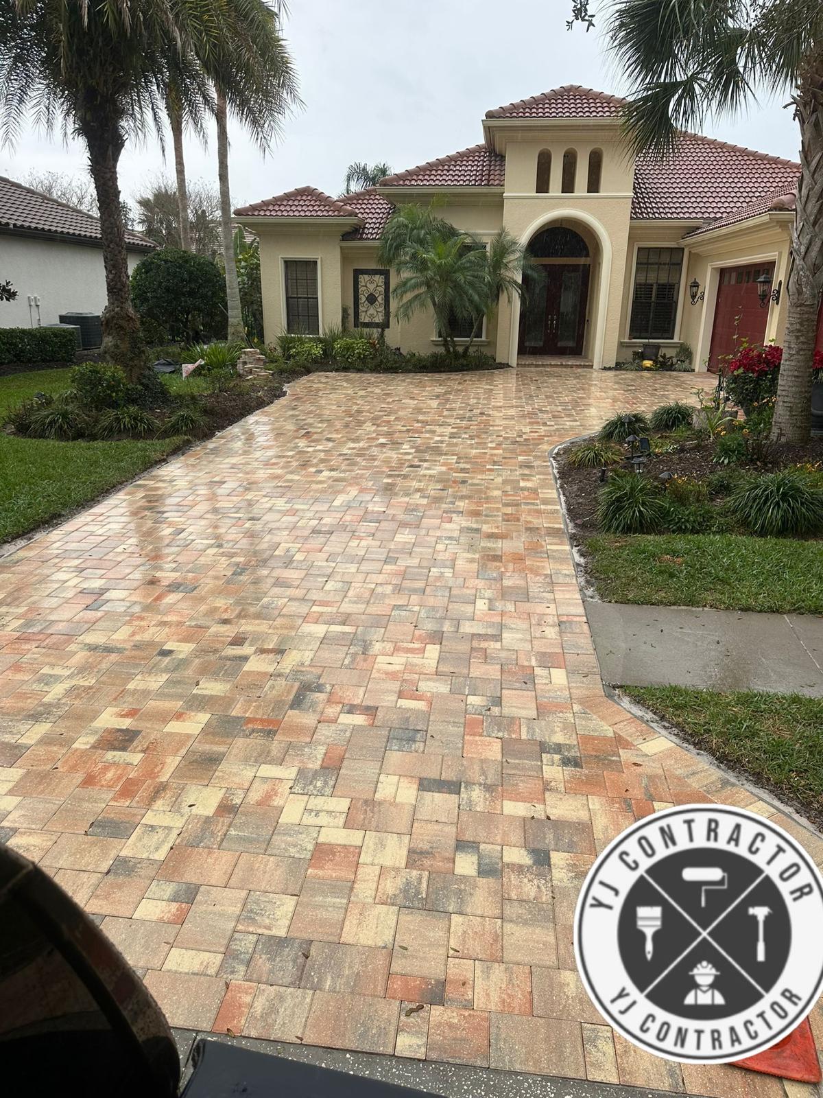 Multicolored paver driveway leading to a home
