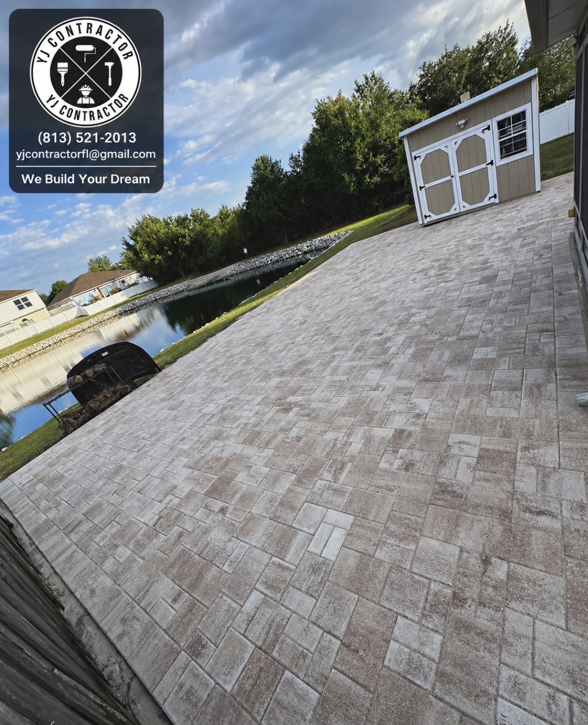 Completed paver patio beside the water