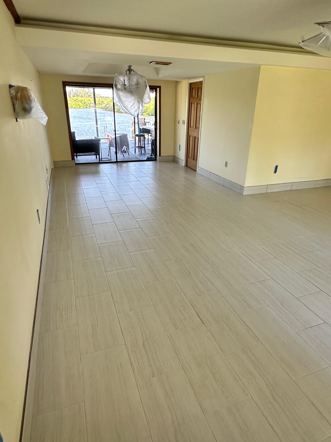 New light-colored floor tile laid through a living room in Clearwater