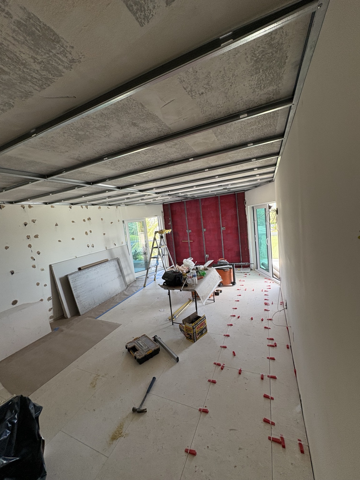 Floor tile installation in progress across a large room