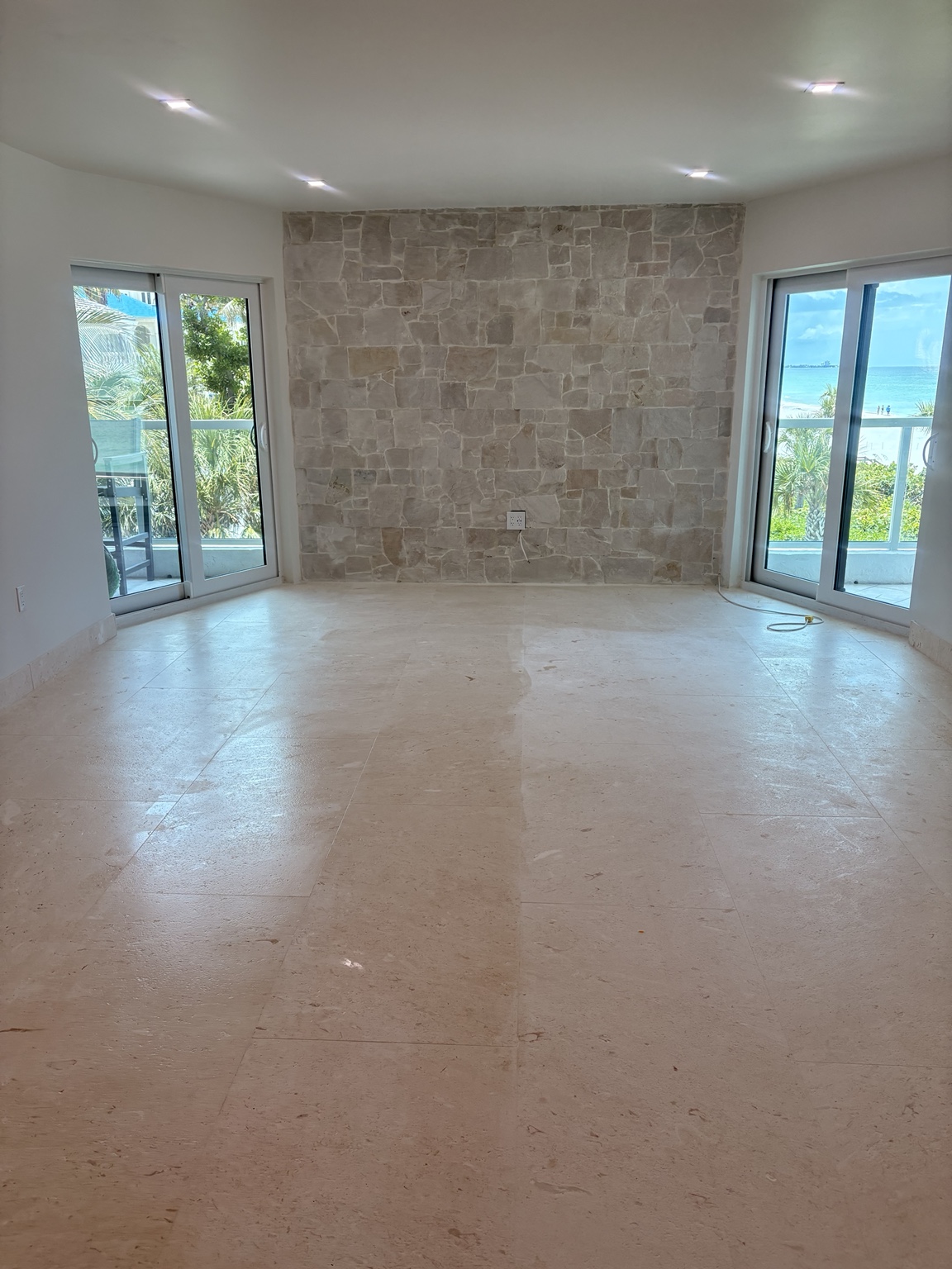 Travertine flooring and natural stone feature wall