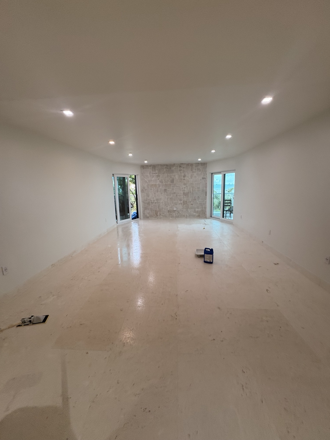 Travertine flooring and stone accent wall in a Longboat Key interior